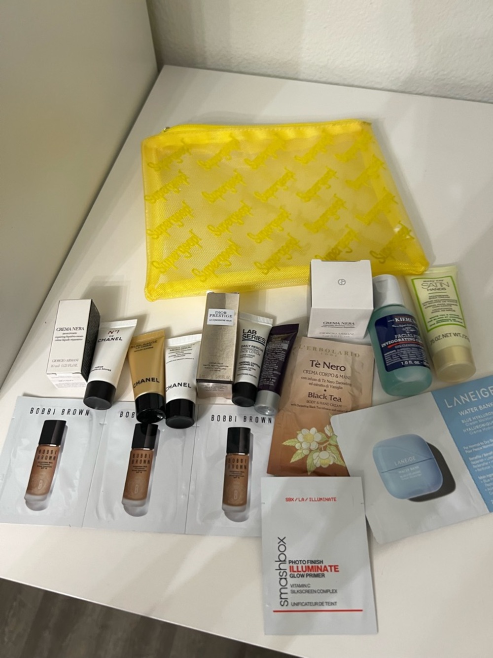 Supergoop! Yellow Mesh Cosmetic Pouch with Skincare & Sample Lot
